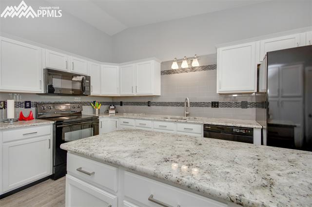 29850 Big Springs Road Calhan, CO 80808 - Photo 9 of 16 Recently (2016 & 2017) updates include granite counter tops, lighting and plumbing fixtures, engineered wood floors, painted cabinets, walls and ceilings. Kitchen appliance upgrades include range/oven, over the range microwave, refrigerator and dishwasher.