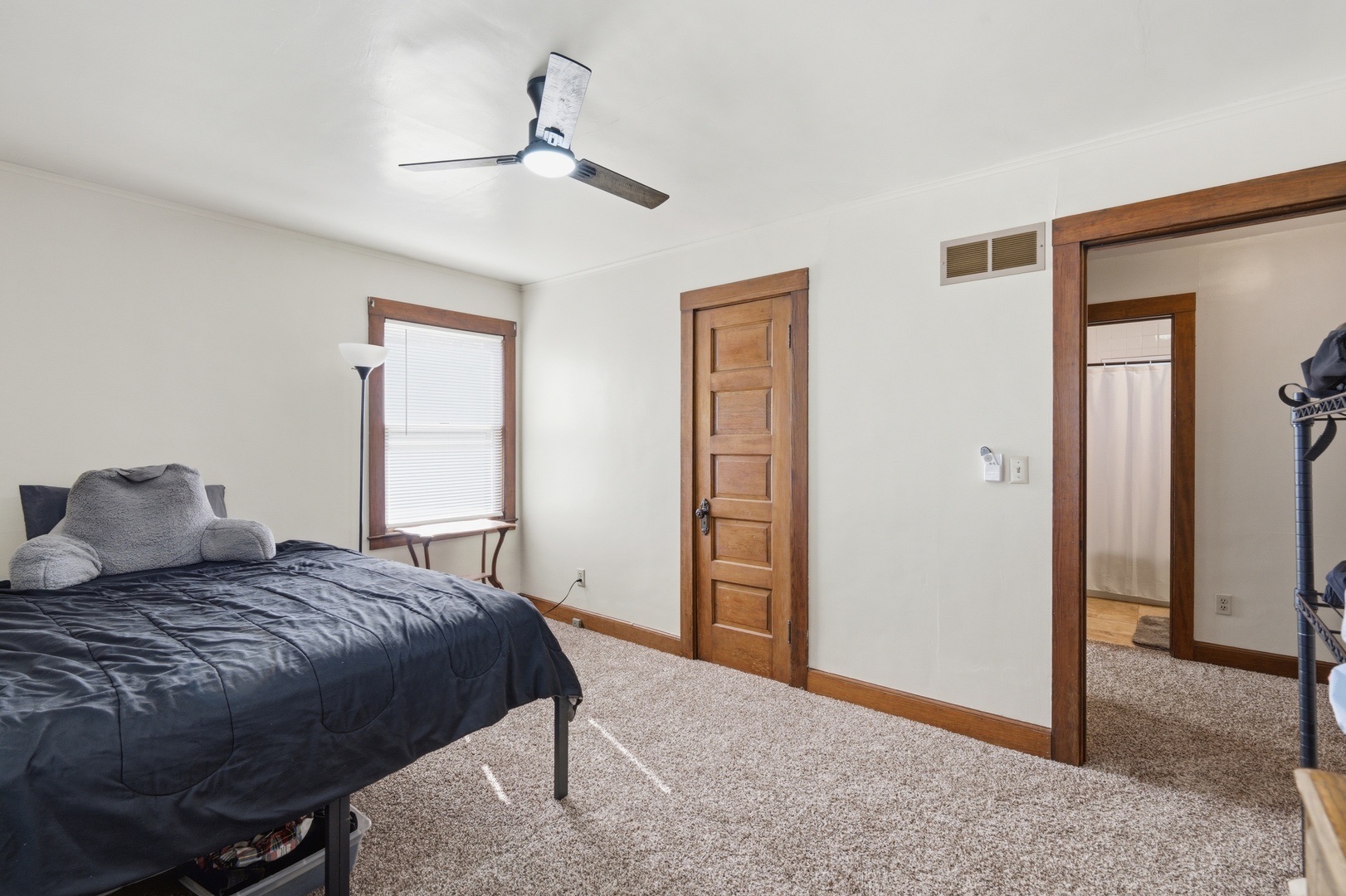 1908 24th Street Moline, IL 61265 - Photo 17 of 32 a bedroom with a large bed and a chandelier