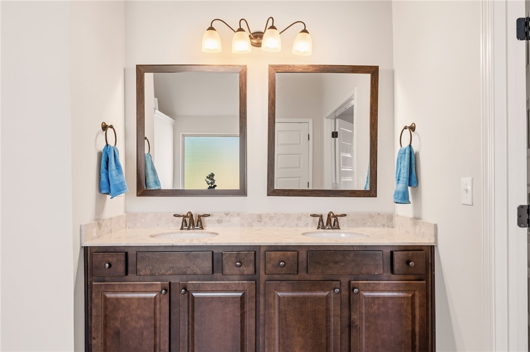 5 Tolkien Drive Anderson, SC 29621 - Photo 23 of 36 Rich wood cabinetry anchors a double vanity topped with elegant stone counters and twin mirrors.