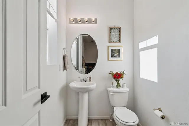 a white toilet sitting next to a bathroom sink