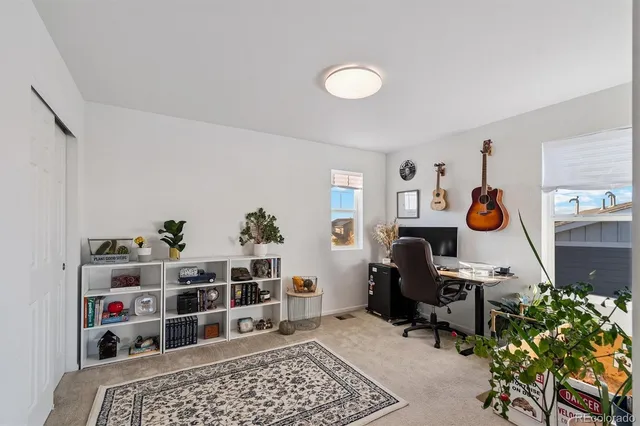 a bedroom with furniture and a book shelf