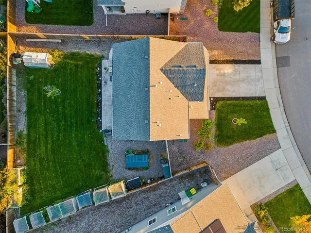 an aerial view of a house with a yard