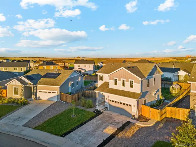 an aerial view of residential houses with outdoor space and street view