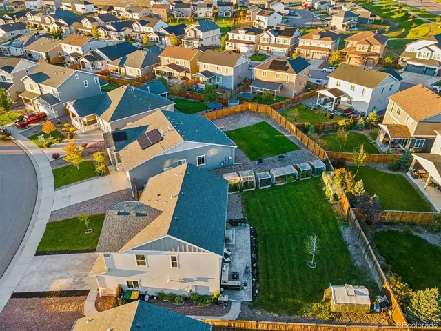 an aerial view of residential houses with outdoor space