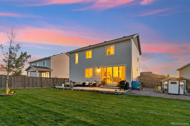 a backyard of a house with table and chairs