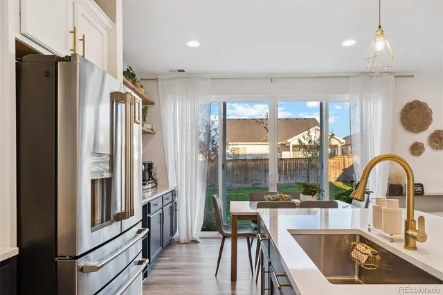 a kitchen with a refrigerator a sink and cabinets