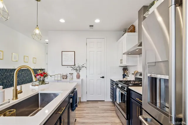 a kitchen with a sink stove and refrigerator
