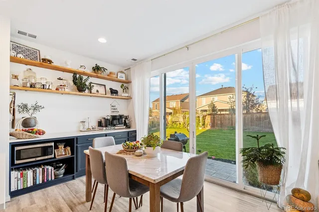 a view of a workspace with furniture and a potted plant