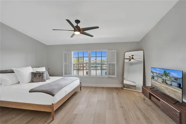 a bedroom with a bed and a large window