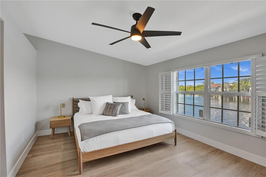 876 Jeffery Street Boca Raton, FL 33487 - Photo 22 of 52 a bedroom with a bed and a large window