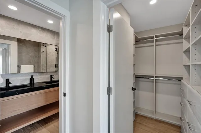 a bathroom with a sink a toilet a mirror and shower