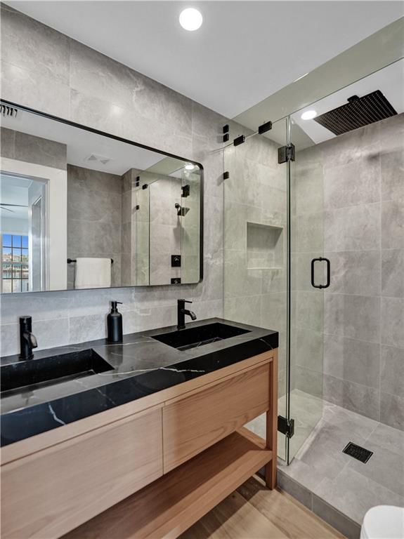 876 Jeffery Street Boca Raton, FL 33487 - Photo 26 of 52 a bathroom with a sink a toilet a mirror and shower