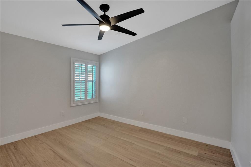 876 Jeffery Street Boca Raton, FL 33487 - Photo 31 of 52 an empty room with wooden floor and windows