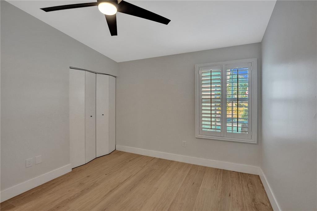 876 Jeffery Street Boca Raton, FL 33487 - Photo 32 of 52 a view of an empty room with wooden floor and a window