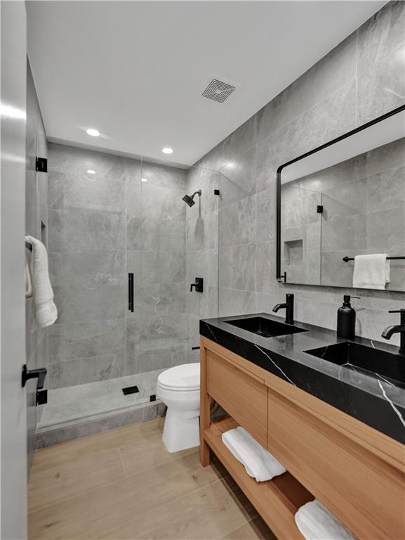 876 Jeffery Street Boca Raton, FL 33487 - Photo 37 of 52 a bathroom with a granite countertop sink a toilet and shower