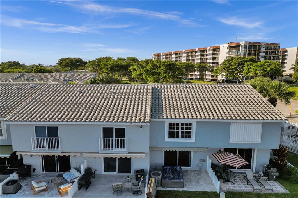 876 Jeffery Street Boca Raton, FL 33487 - Photo 51 of 52 a view of a patio with table and chairs and potted plants
