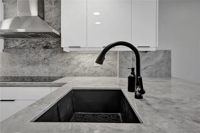 a kitchen with a sink and a stove