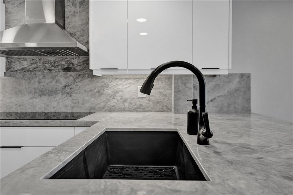 876 Jeffery Street Boca Raton, FL 33487 - Photo 8 of 52 a kitchen with a sink and a stove