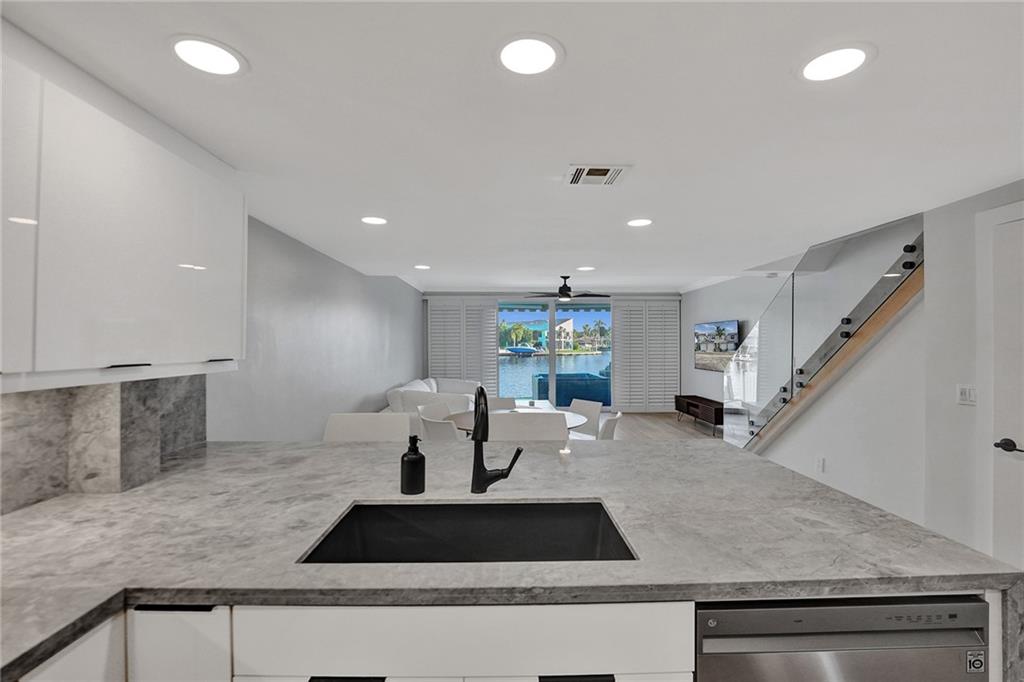 876 Jeffery Street Boca Raton, FL 33487 - Photo 9 of 52 a large white kitchen with a large window