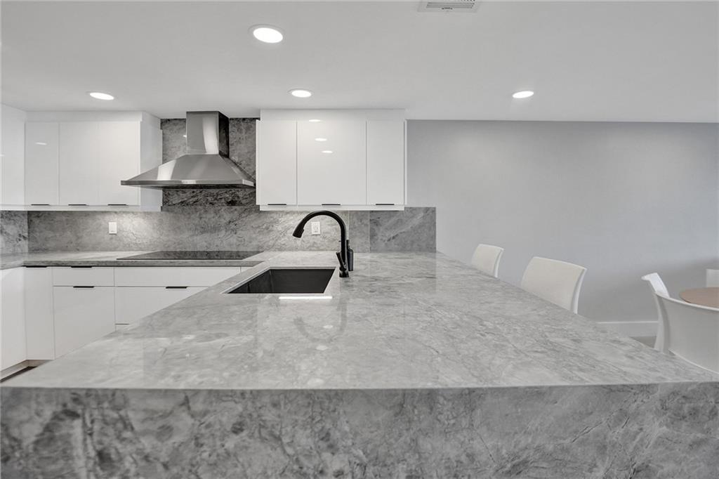 876 Jeffery Street Boca Raton, FL 33487 - Photo 10 of 52 a kitchen with a sink and white cabinets