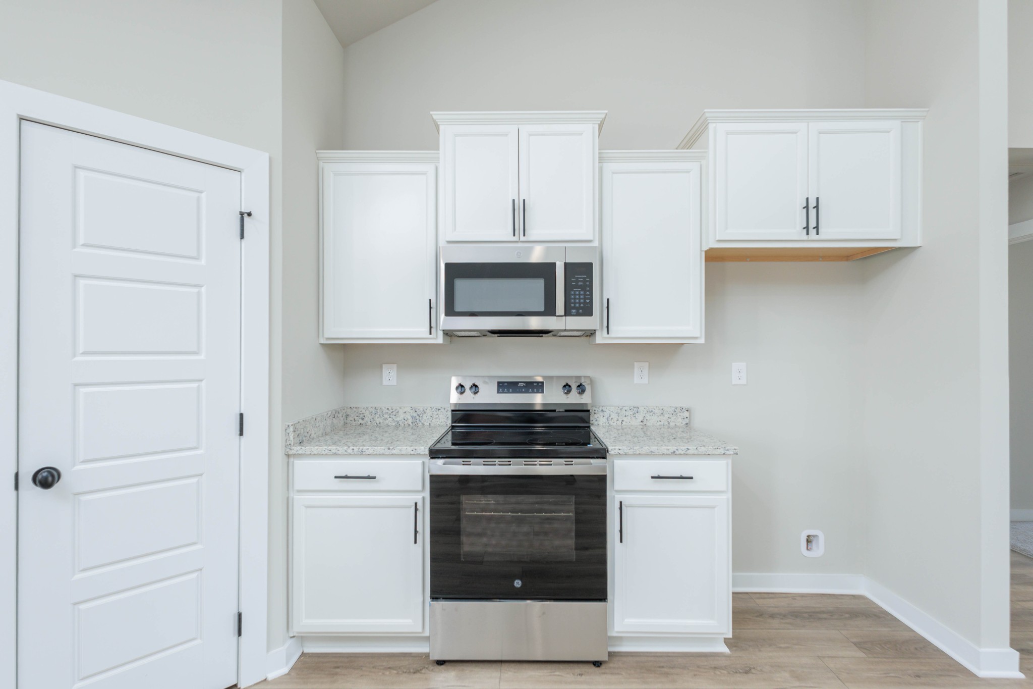 6261 Piney River Road Dickson, TN 37055 - Photo 16 of 32 a kitchen with white cabinets and stainless steel appliances