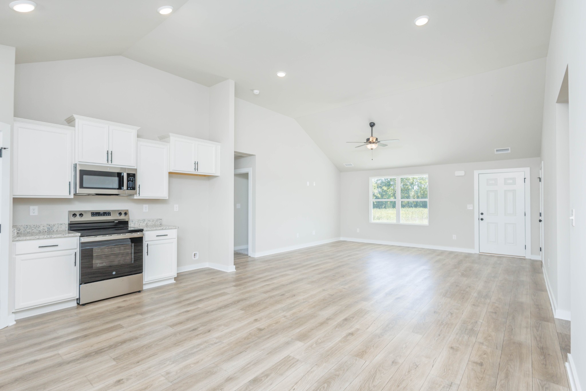6261 Piney River Road Dickson, TN 37055 - Photo 17 of 32 a kitchen with stainless steel appliances granite countertop a stove a sink and a refrigerator