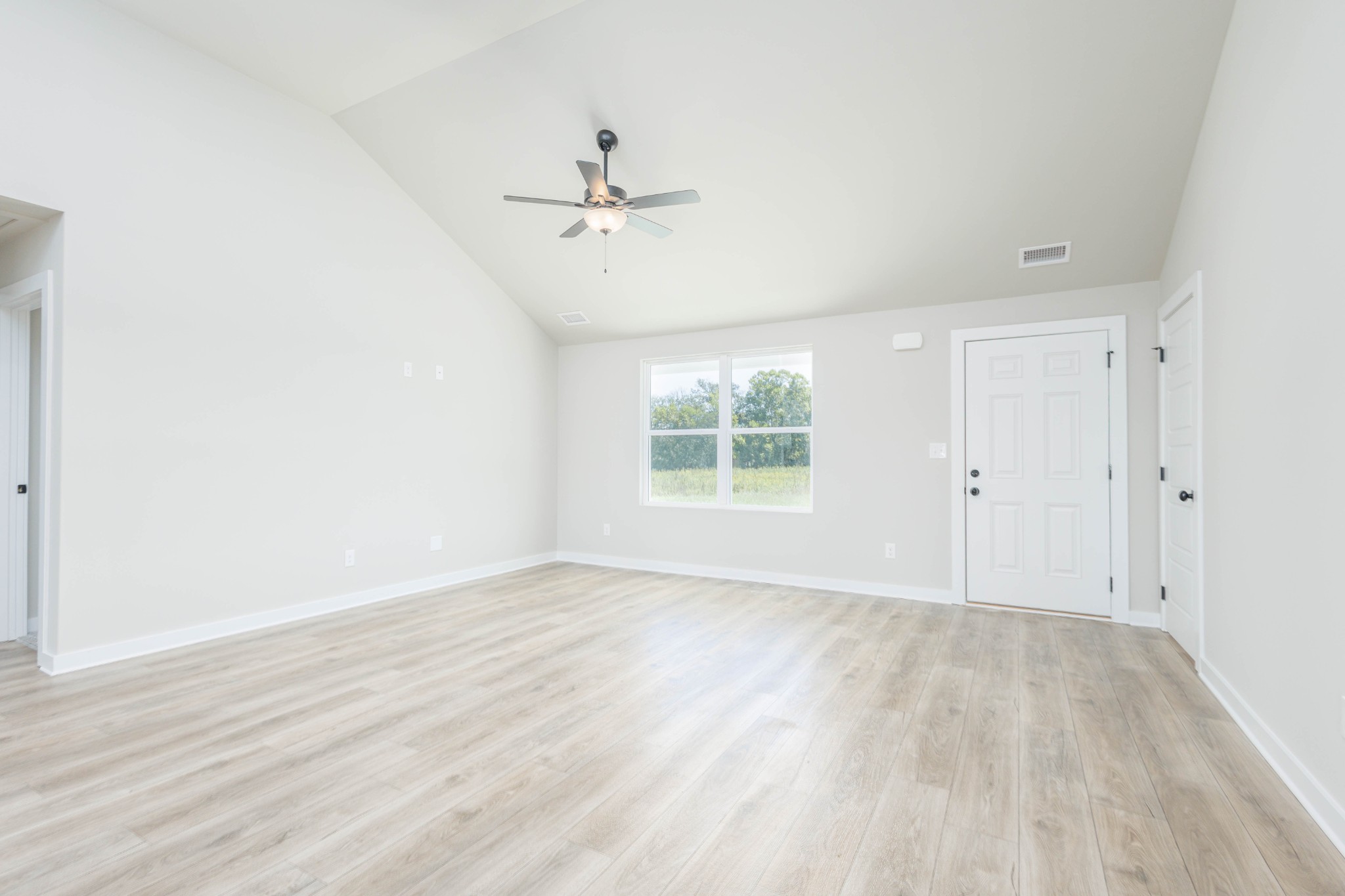 6261 Piney River Road Dickson, TN 37055 - Photo 18 of 32 a view of an empty room with a window and wooden floor