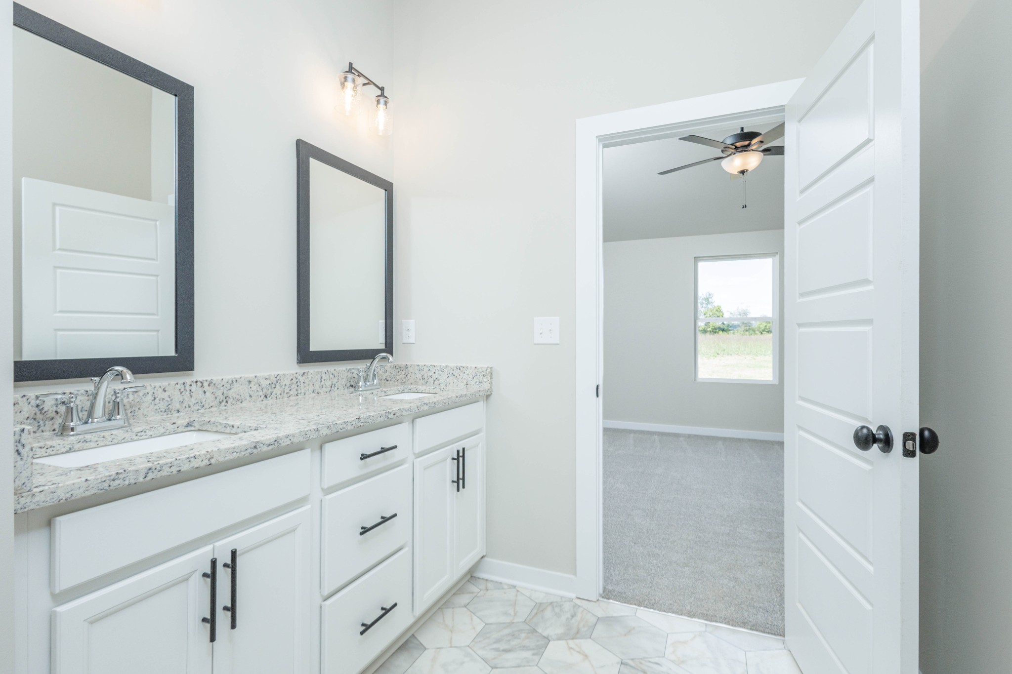 6261 Piney River Road Dickson, TN 37055 - Photo 27 of 32 a bathroom with a granite countertop sink and a mirror