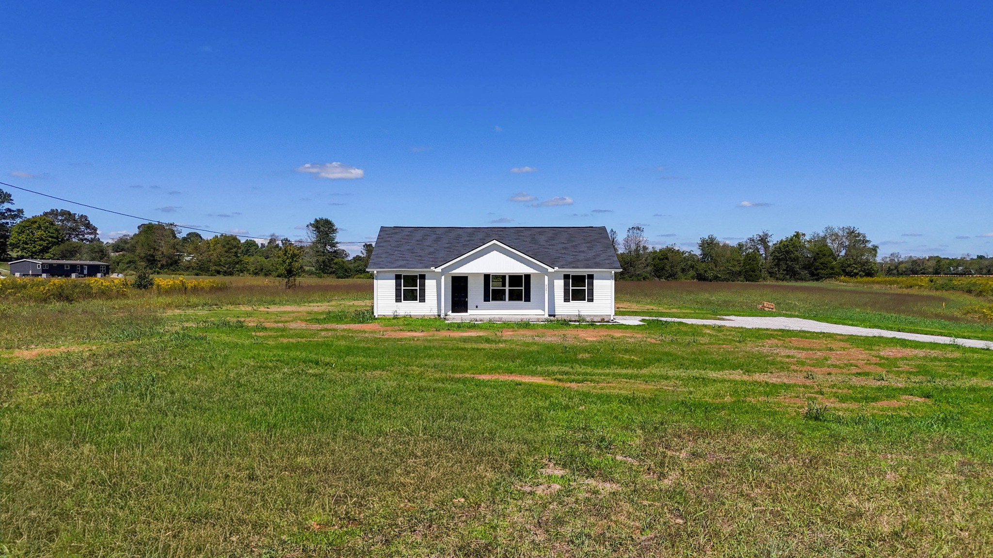 6261 Piney River Road Dickson, TN 37055 - Photo 3 of 32 a front view of a house with a garden