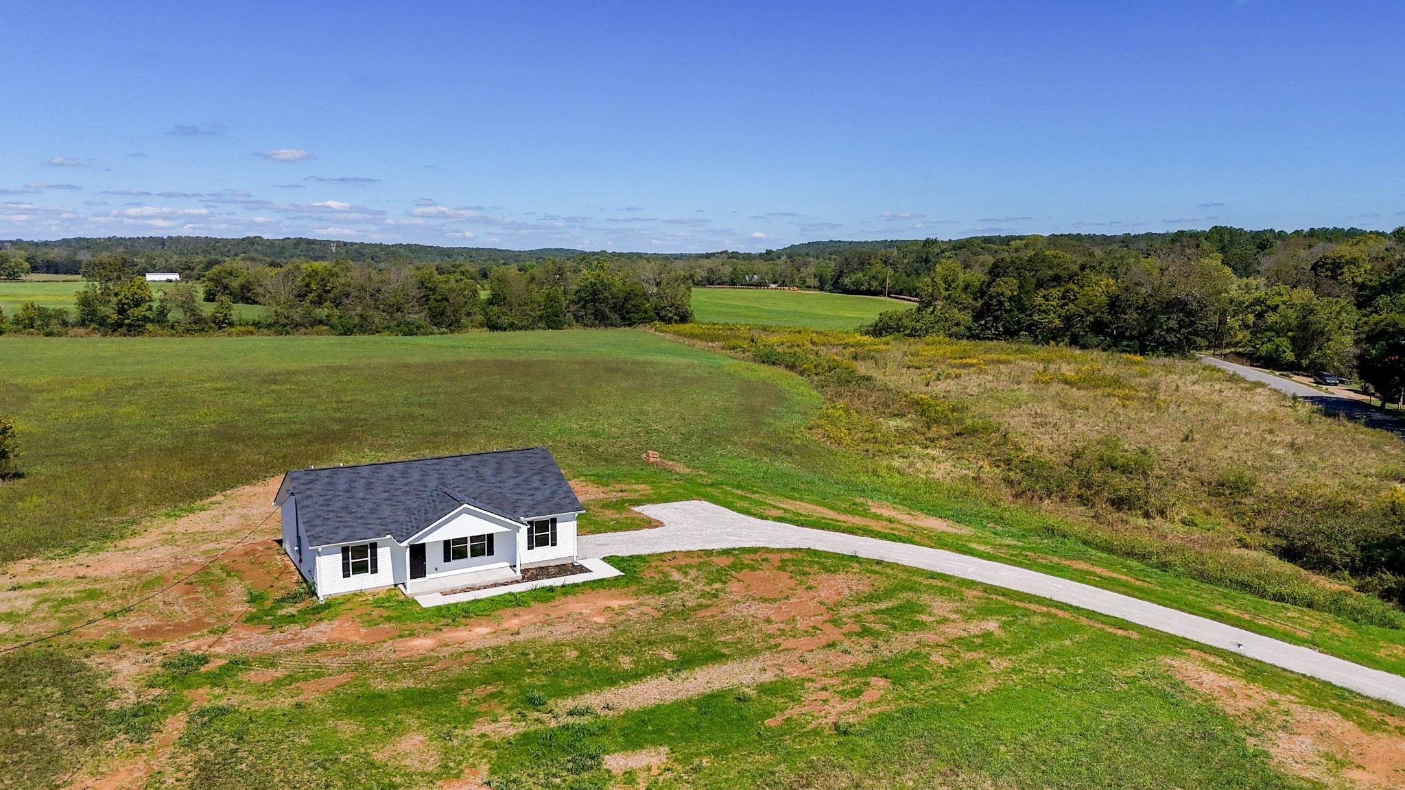 6261 Piney River Road Dickson, TN 37055 - Photo 7 of 32 a view of a lake with a house in the background