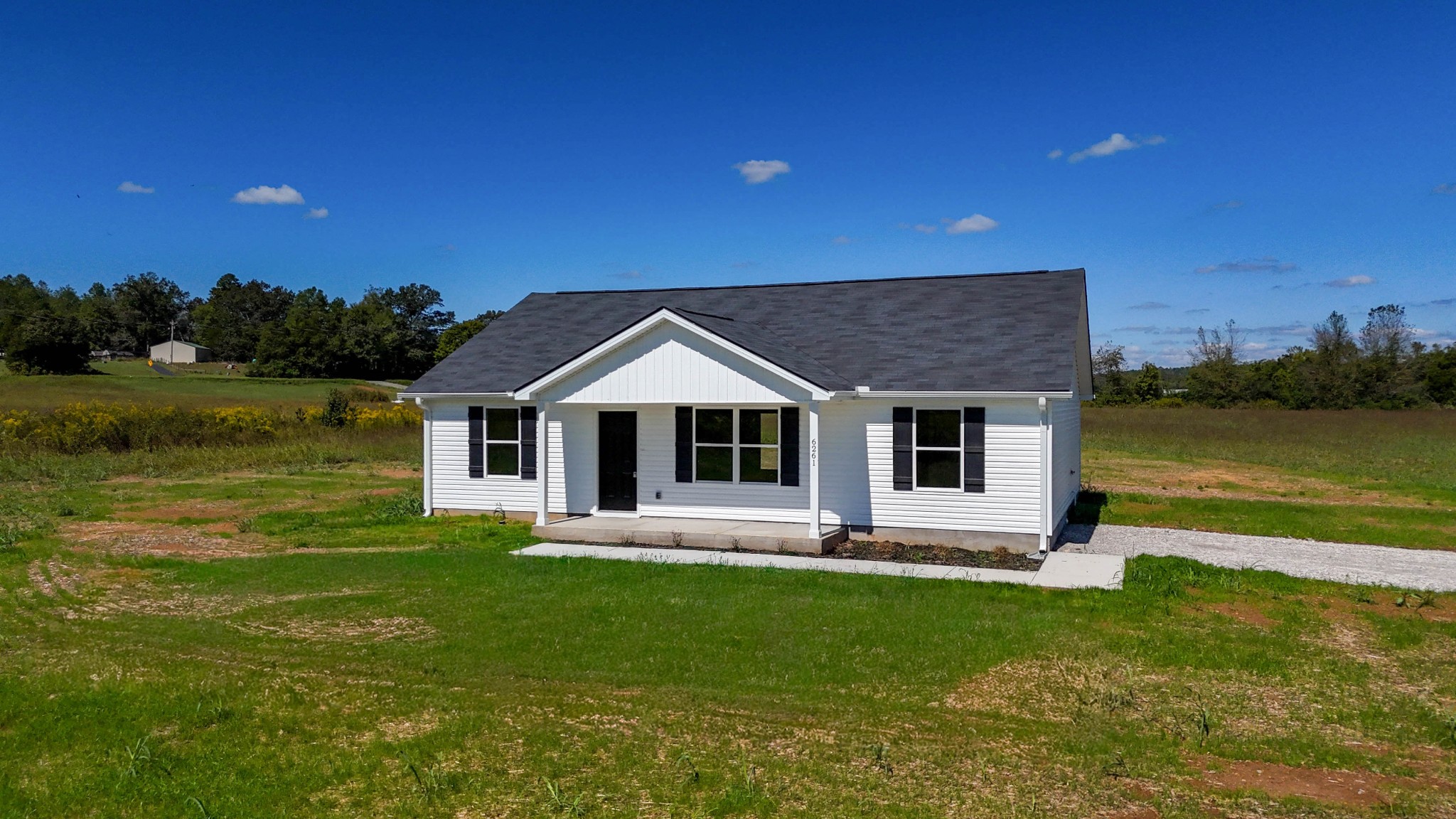 6261 Piney River Road Dickson, TN 37055 - Photo 10 of 32 a front view of a house with a yard table and chairs