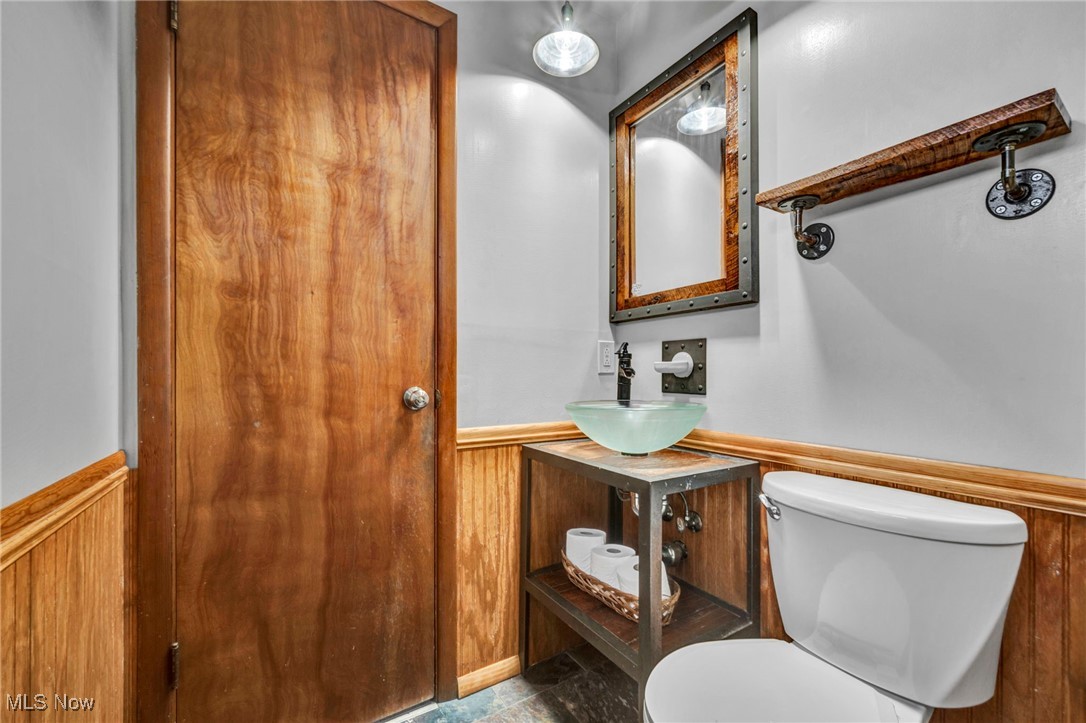 36462 Chestnut Ridge Road North Ridgeville, OH 44039 - Photo 11 of 47 Bathroom featuring a wainscoted wall, wood walls, and vanity