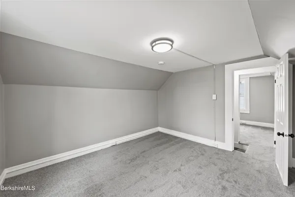 an empty room with a empty space and windows