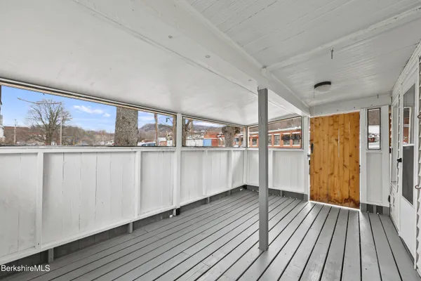 a view of a living room with furniture and wooden floor
