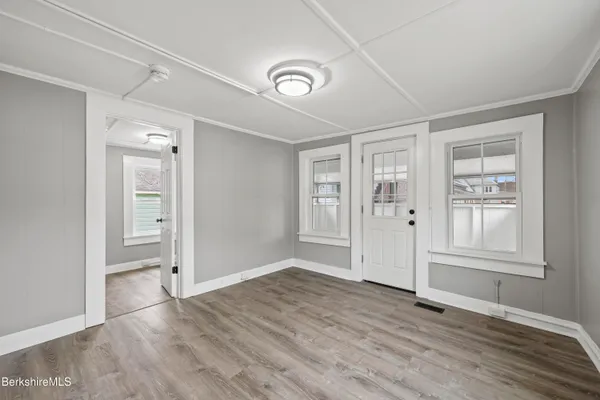 wooden floor in an empty room with a window