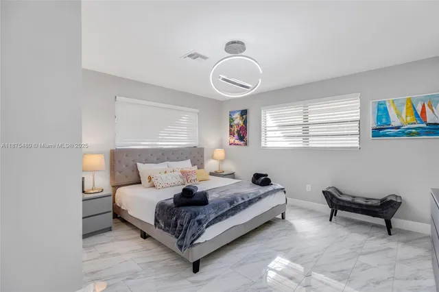 a bedroom with a bed and a lamp