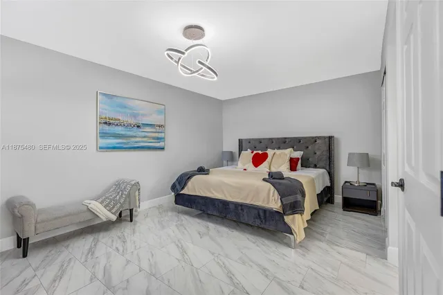 a bedroom with a bed and a mirror