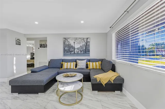 a living room with furniture and a window