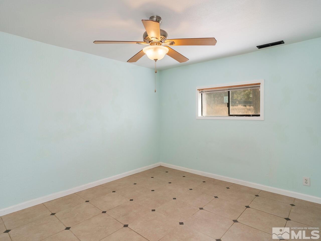 8515 Gate Street Reno, NV 89506 - Photo 15 of 19 an empty room with a window and a fan