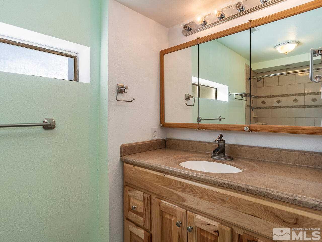 8515 Gate Street Reno, NV 89506 - Photo 16 of 19 a bathroom with a sink and a mirror