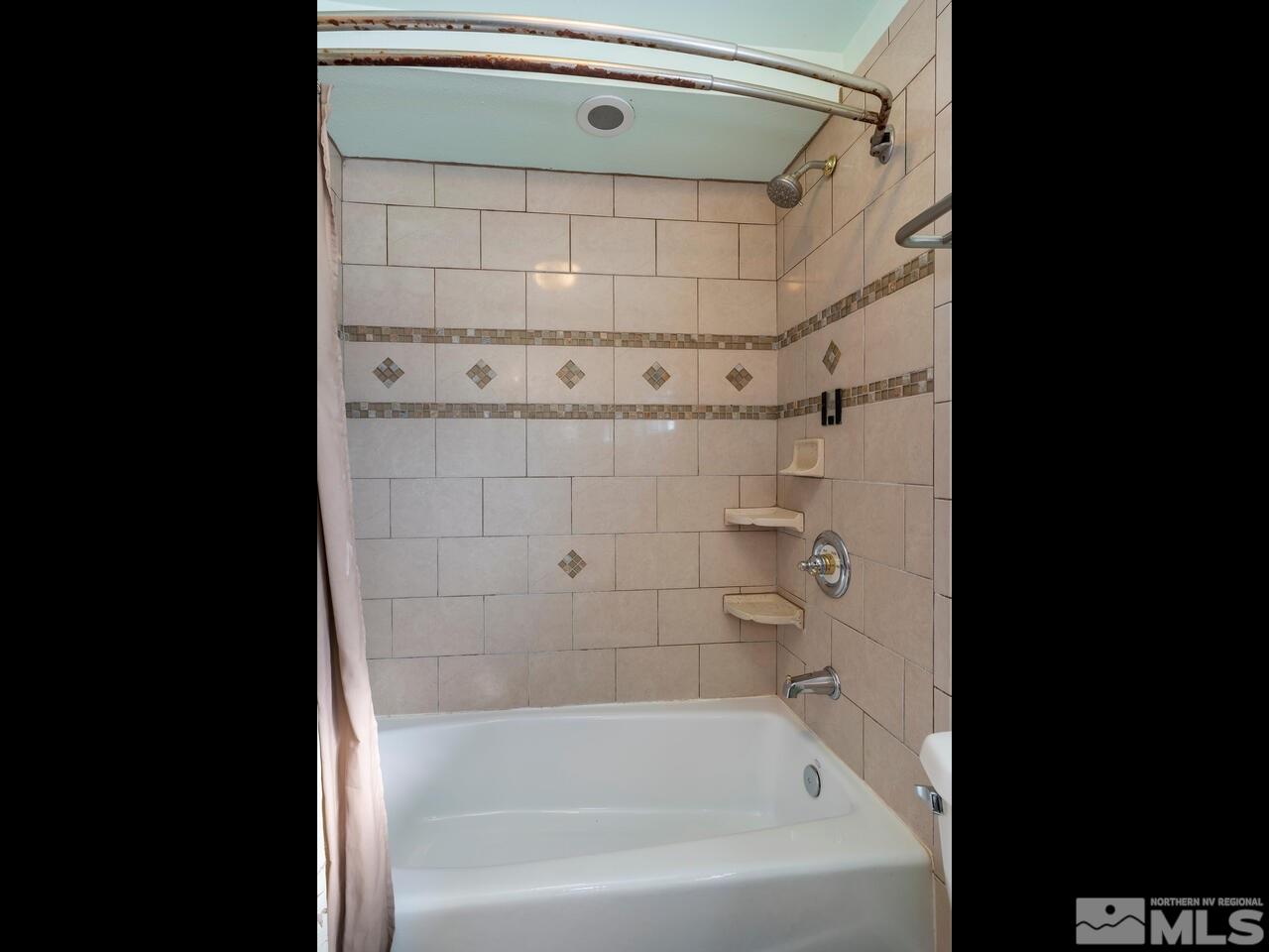 8515 Gate Street Reno, NV 89506 - Photo 17 of 19 a bathroom with a bathtub and shower