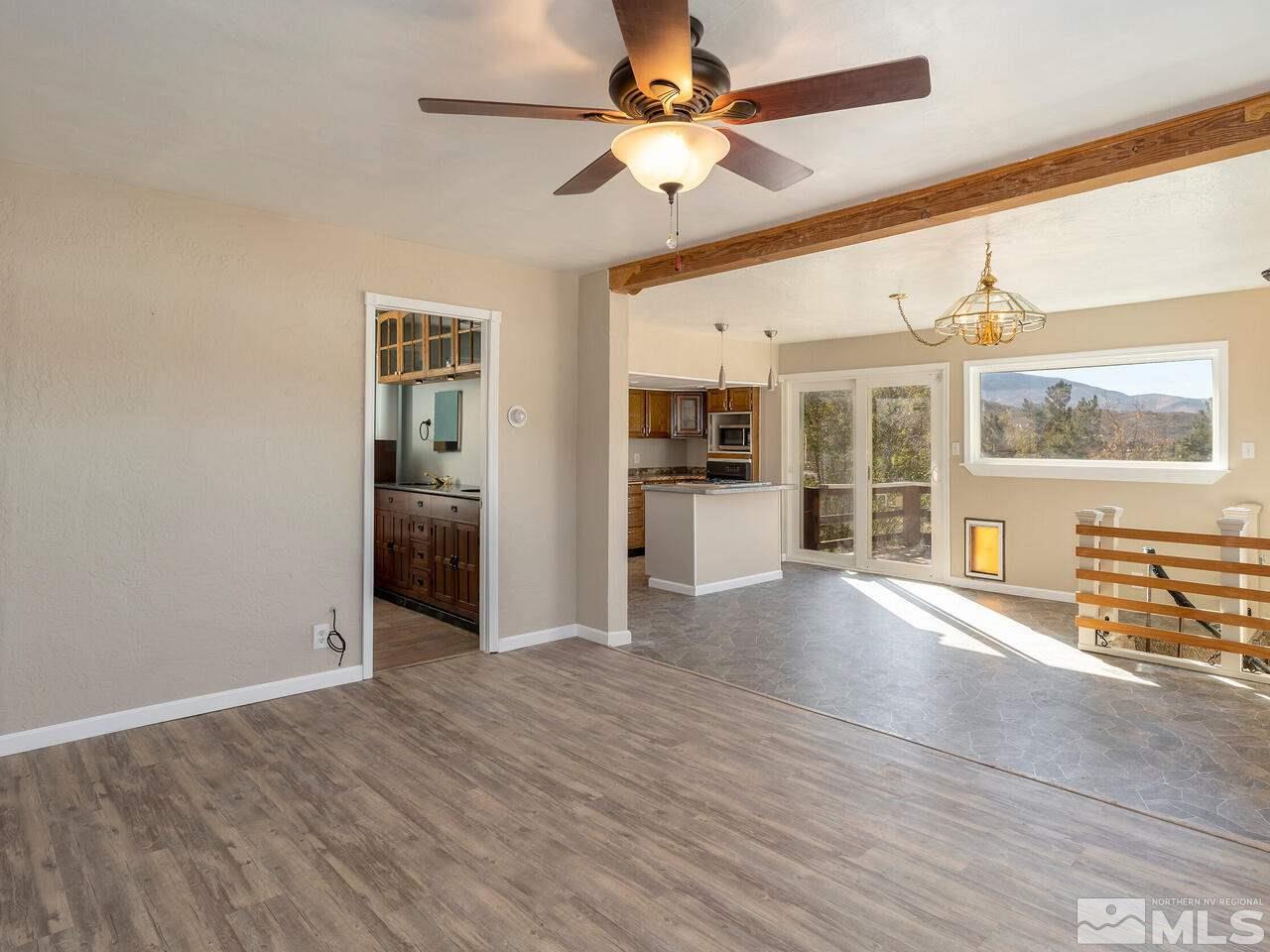 8515 Gate Street Reno, NV 89506 - Photo 4 of 19 a view of an empty room with a window and wooden floor