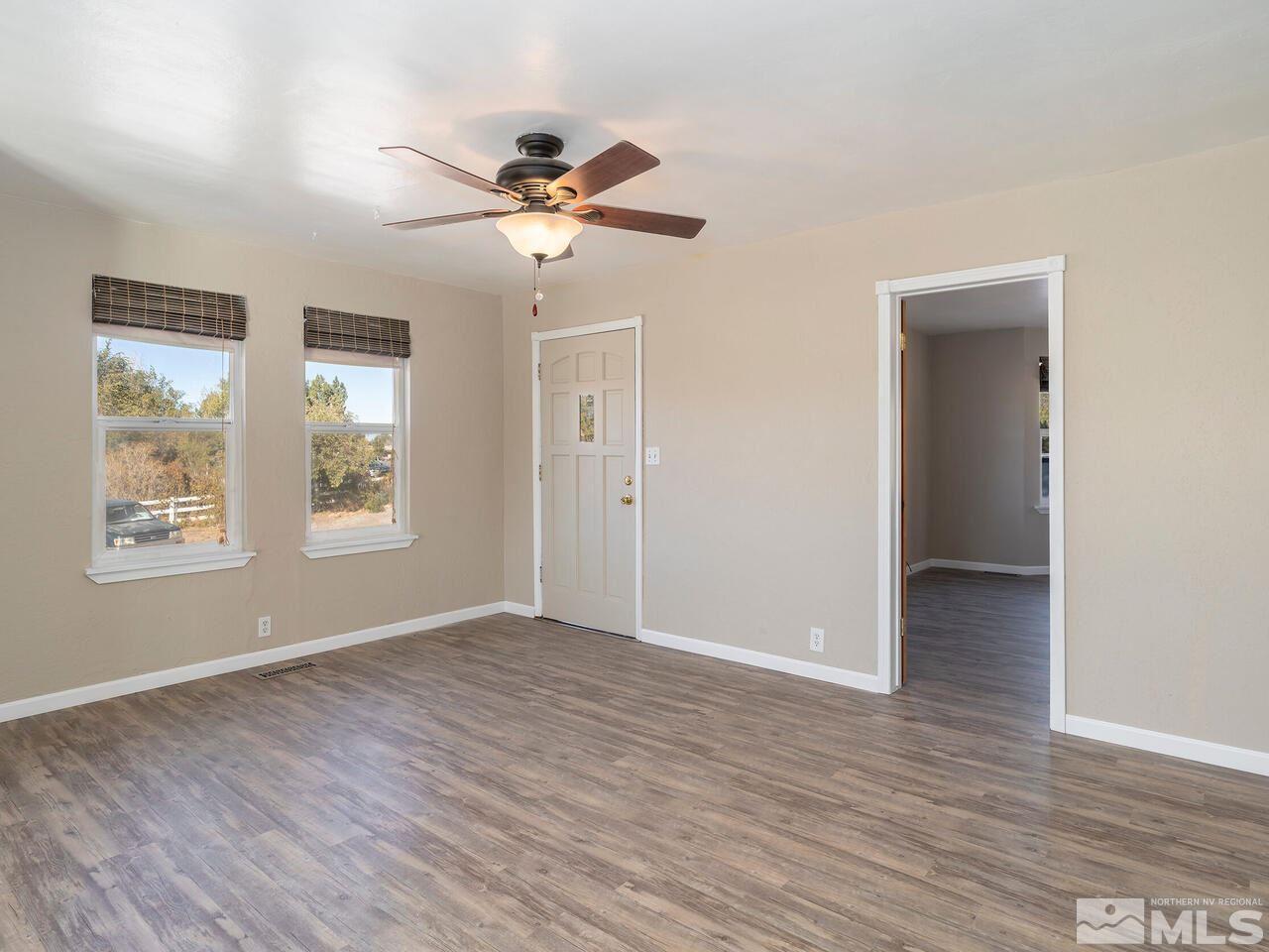 8515 Gate Street Reno, NV 89506 - Photo 5 of 19 a view of an empty room with wooden floor and a window