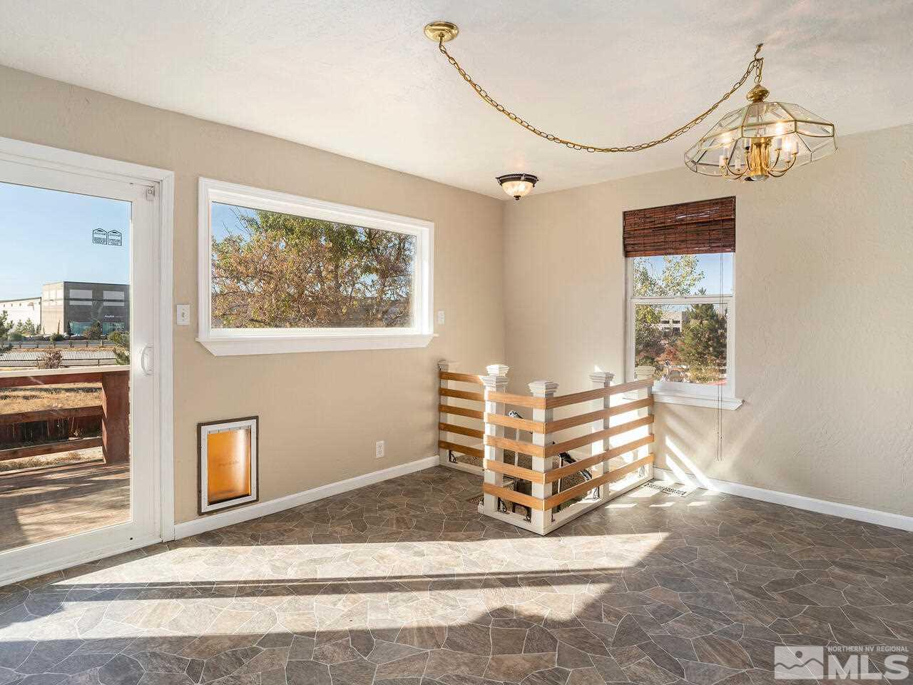8515 Gate Street Reno, NV 89506 - Photo 7 of 19 a view of a livingroom with wooden cabinets and a window