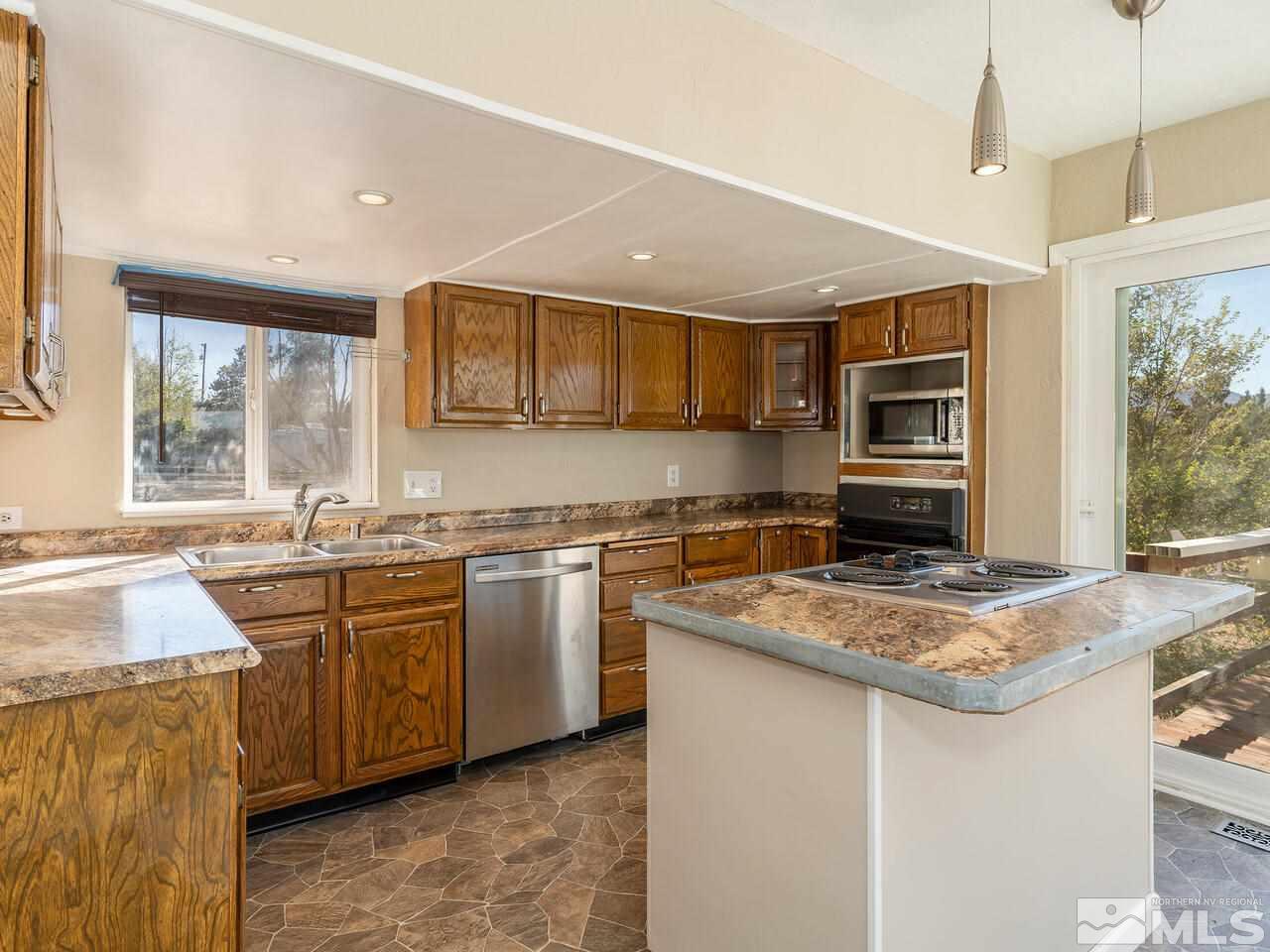 8515 Gate Street Reno, NV 89506 - Photo 8 of 19 a kitchen with stainless steel appliances granite countertop a sink stove and refrigerator