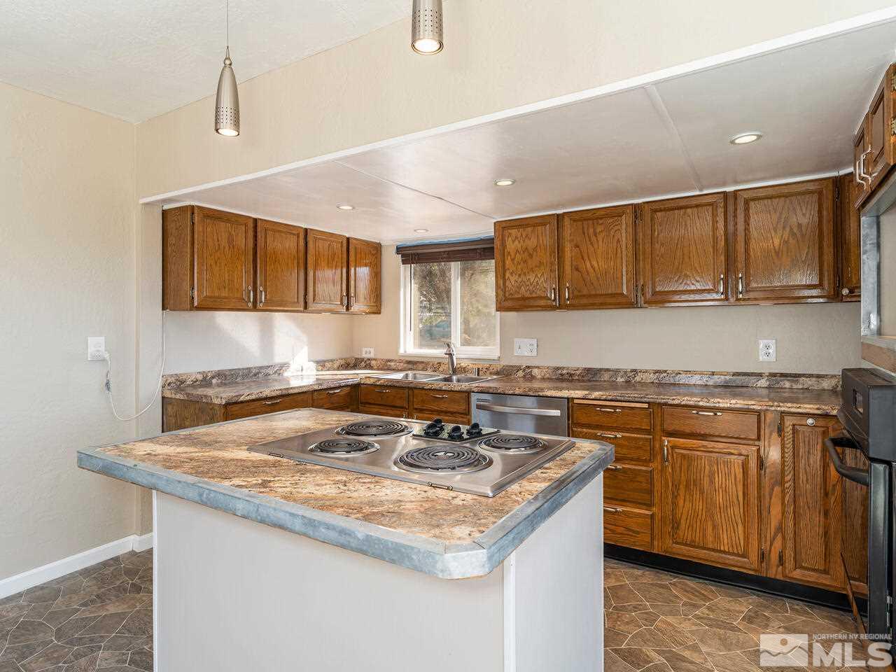 8515 Gate Street Reno, NV 89506 - Photo 9 of 19 a kitchen with stainless steel appliances granite countertop a sink stove and cabinets