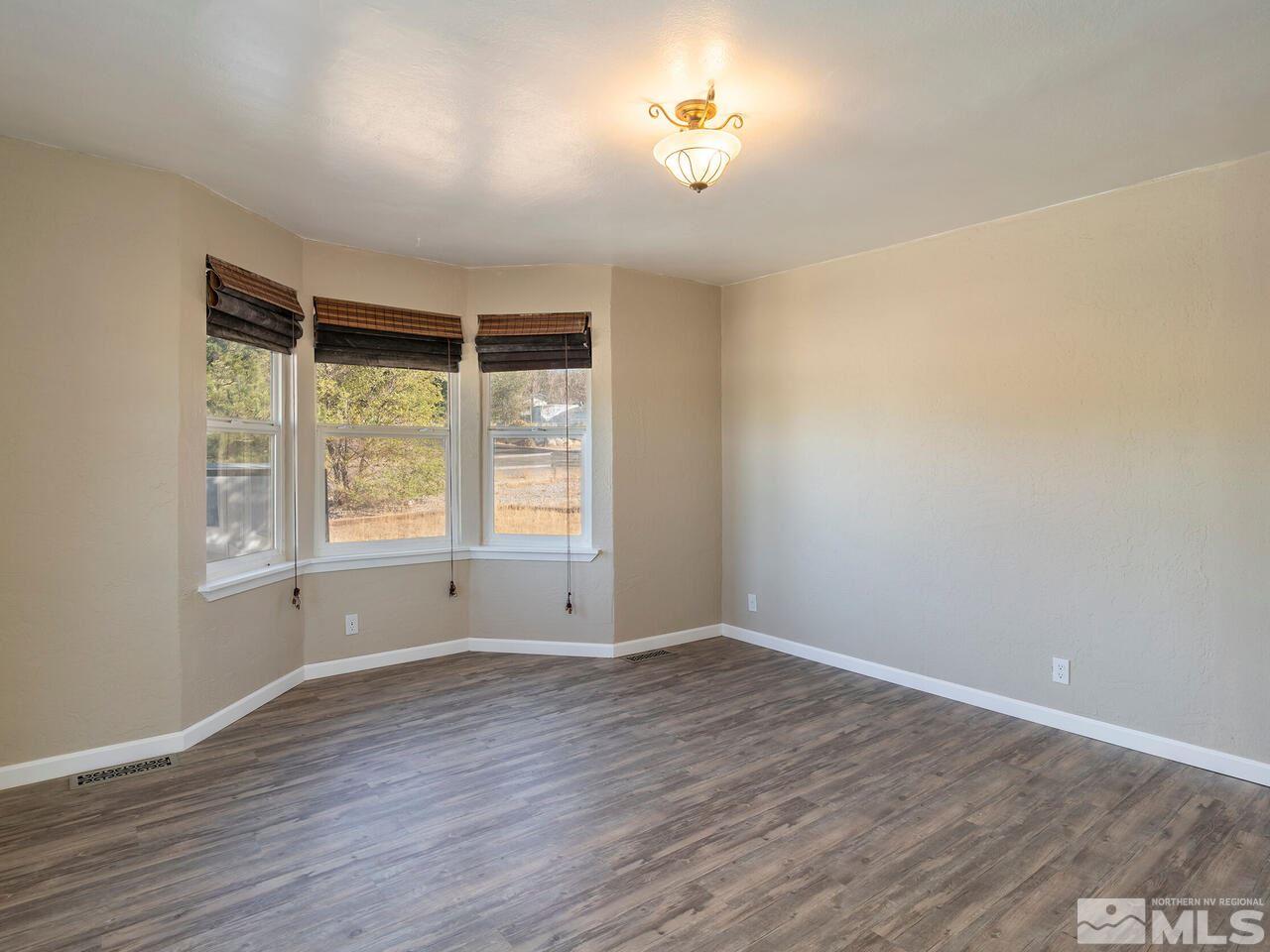 8515 Gate Street Reno, NV 89506 - Photo 10 of 19 wooden floor in an empty room with a window