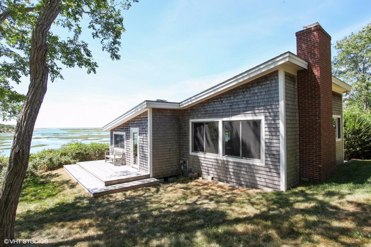 5 Slade Hill Road Truro, MA 02666 - Photo 2 of 15 a view of a house with a yard and floor to ceiling window