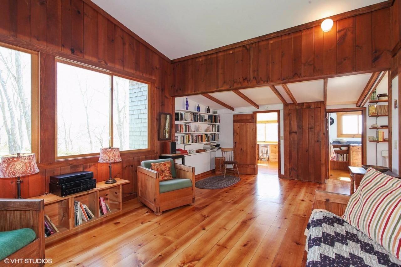 5 Slade Hill Road Truro, MA 02666 - Photo 6 of 15 a living room with furniture a fireplace and large windows