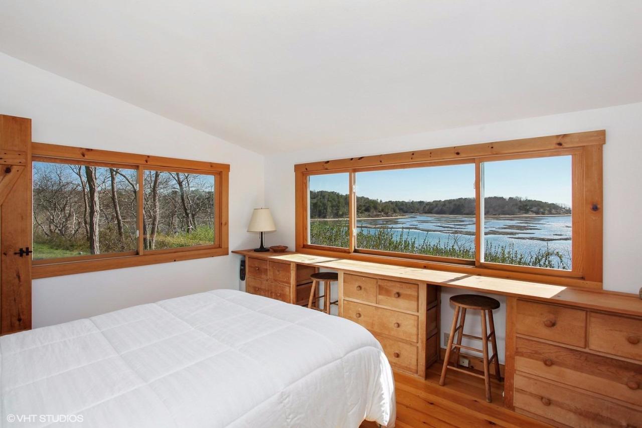 5 Slade Hill Road Truro, MA 02666 - Photo 10 of 15 a bedroom with a large window and a bed